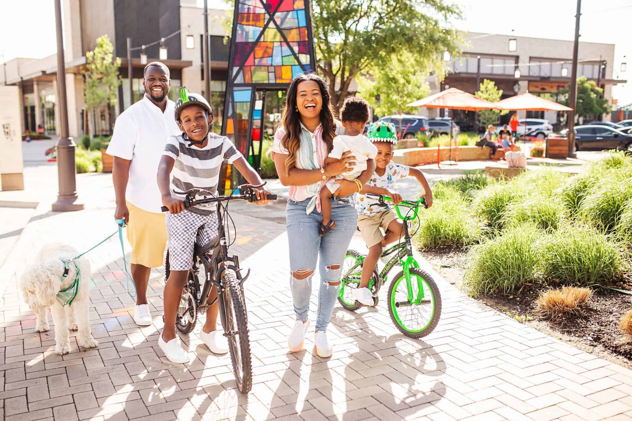 Top 40 Fun Summer Activities for Kids featured by top US life and style blog, Glamorous Versatility: image of a family going on a bike ride