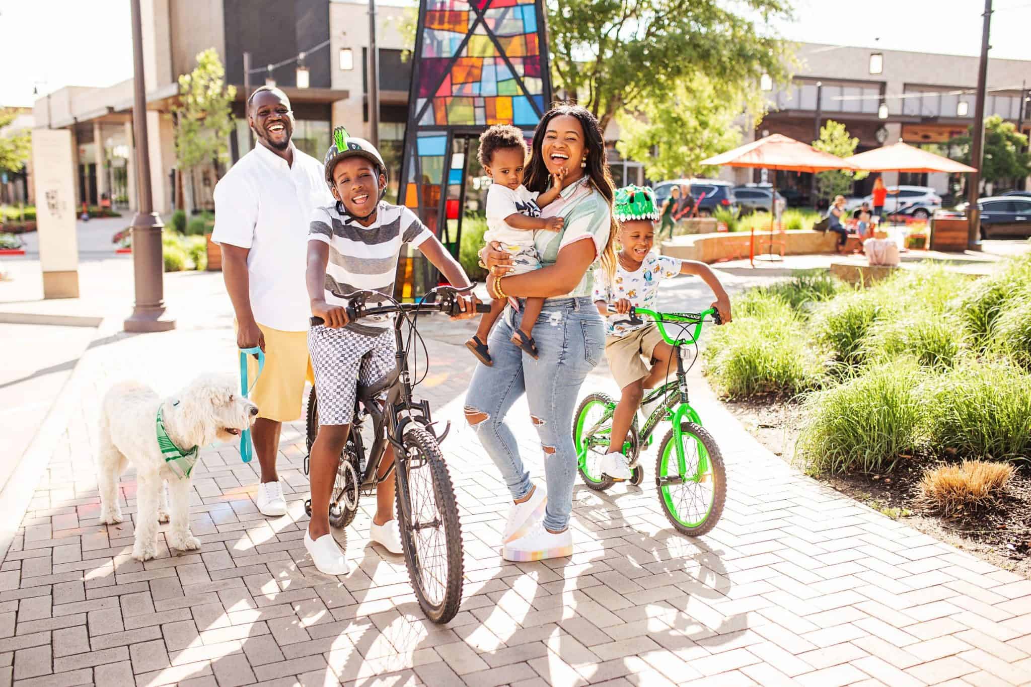 Top 40 Fun Summer Activities for Kids featured by top US life and style blog, Glamorous Versatility: image of a family going on a bike ride