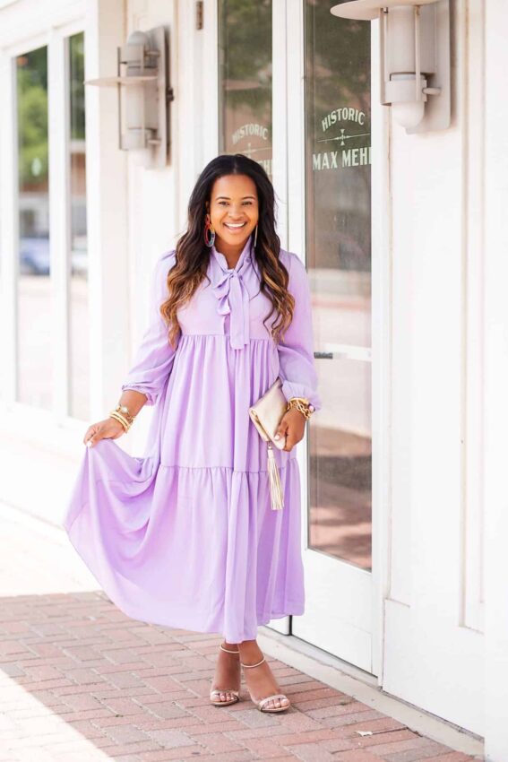 Affordable purple clothing featured by top US fashion blog, Glamorous Versatility: image of a woman wearing a Boohoo oversized purple dress.