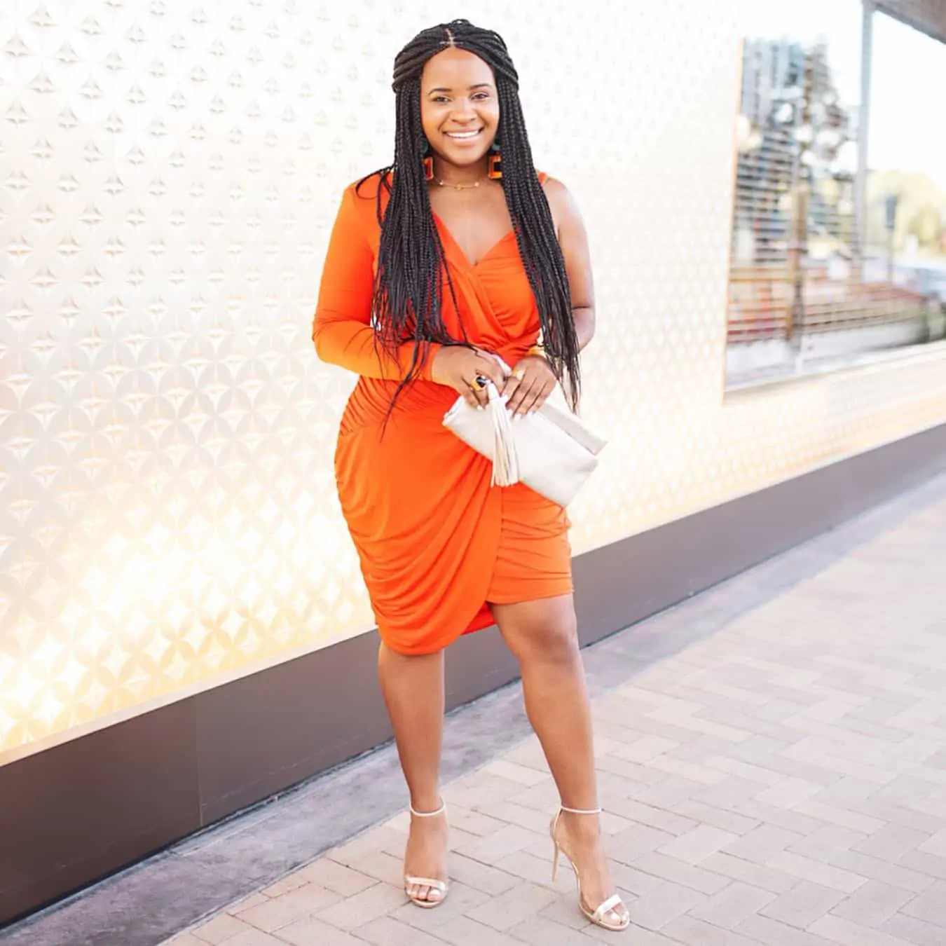 Summer Date Night Outfits featured by top US fashion blog, Glamorous Versatility: image of a woman wearing an orange Bebe dress and Steve Madden metallic sandals.