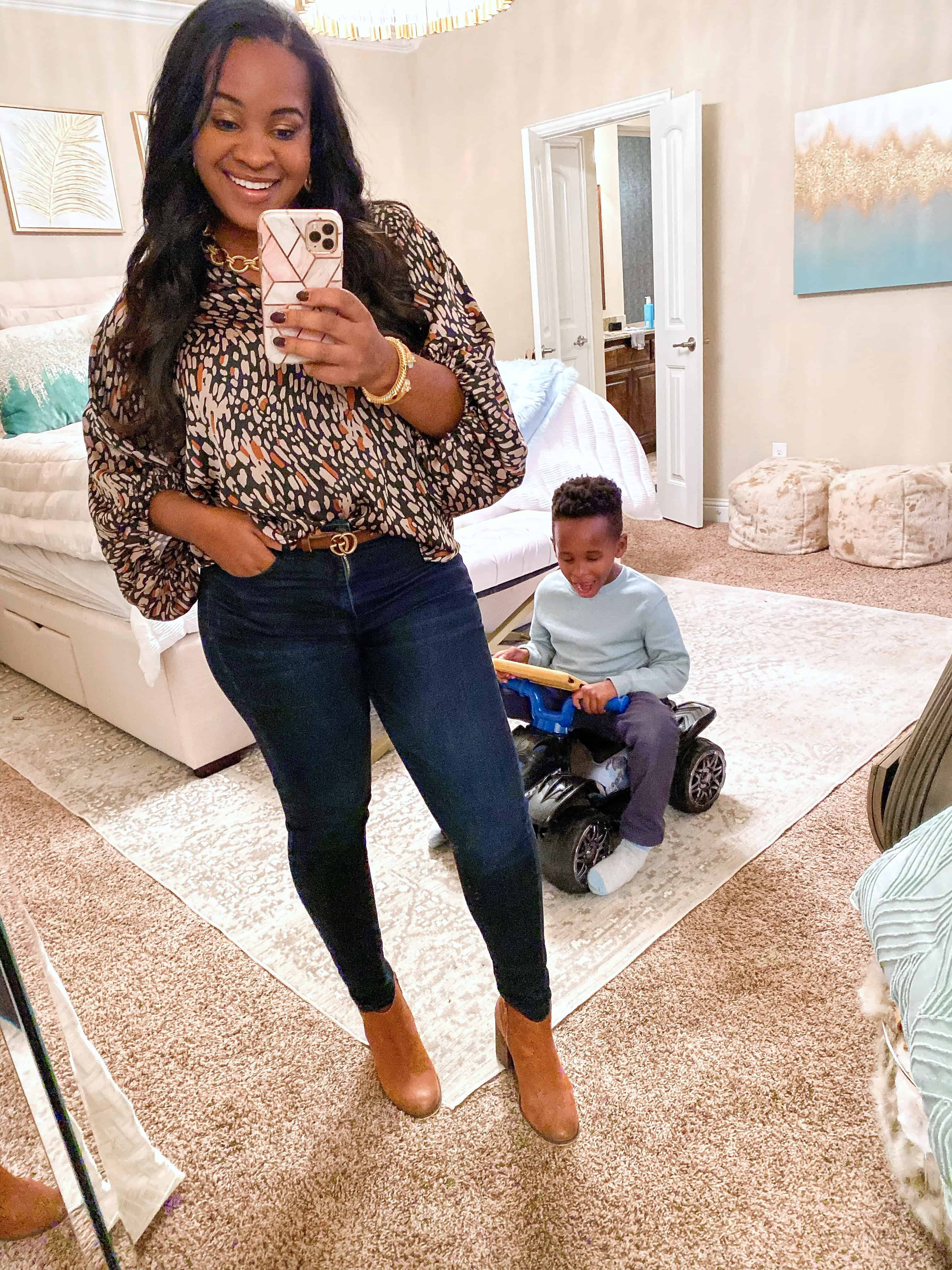 4 Cute Thanksgiving Outfit Ideas featured by top US fashion blog, Glamorous Versatility: image of a woman wearing a patterned blouse, skinny jeans and ankle booties