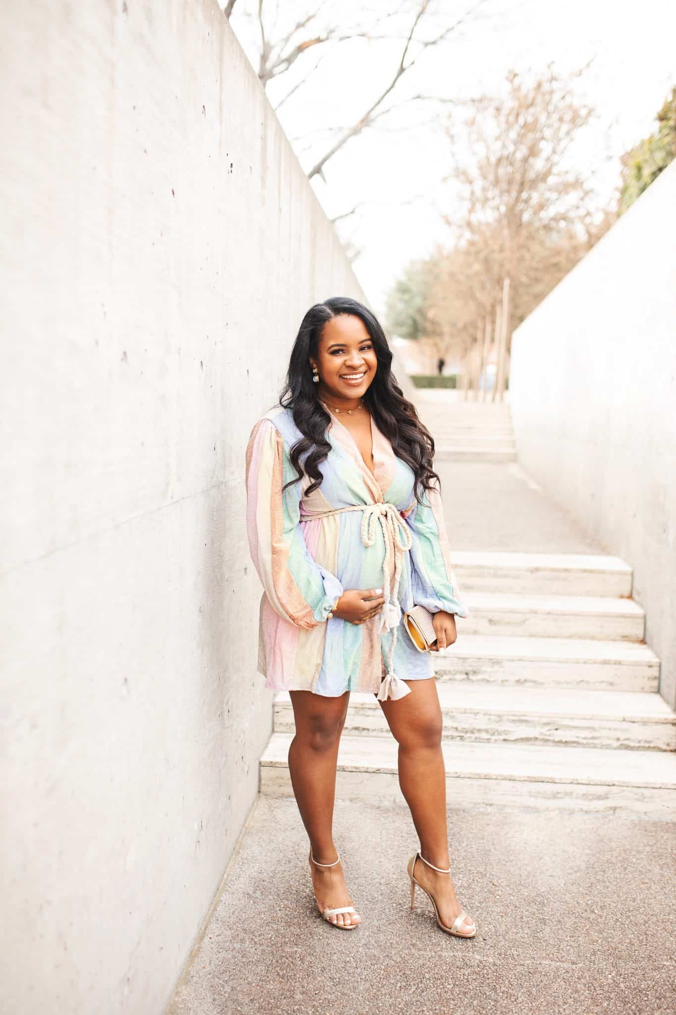 How to Prepare for a Successful New Year by popular Dallas life and style blog, Glamorous Versatility: image of a pregnant woman standing outside and wearing a pastel stripe romper. 