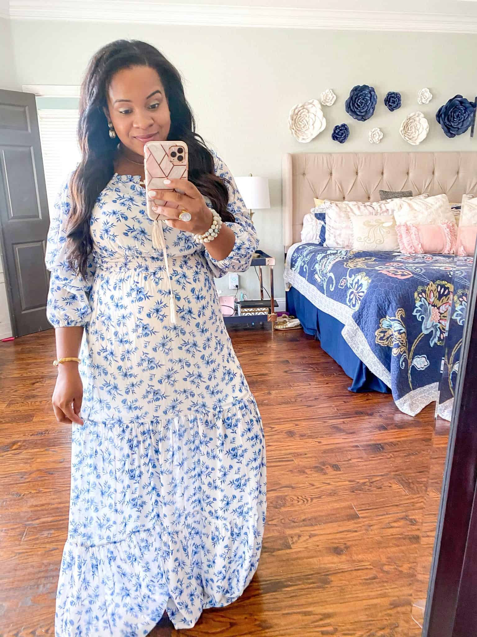 Baby Shower Dress Ideas by popular Dallas fashion blog, Glamorous Versatility: image of a woman wearing a blue and white floral maxi dress. 