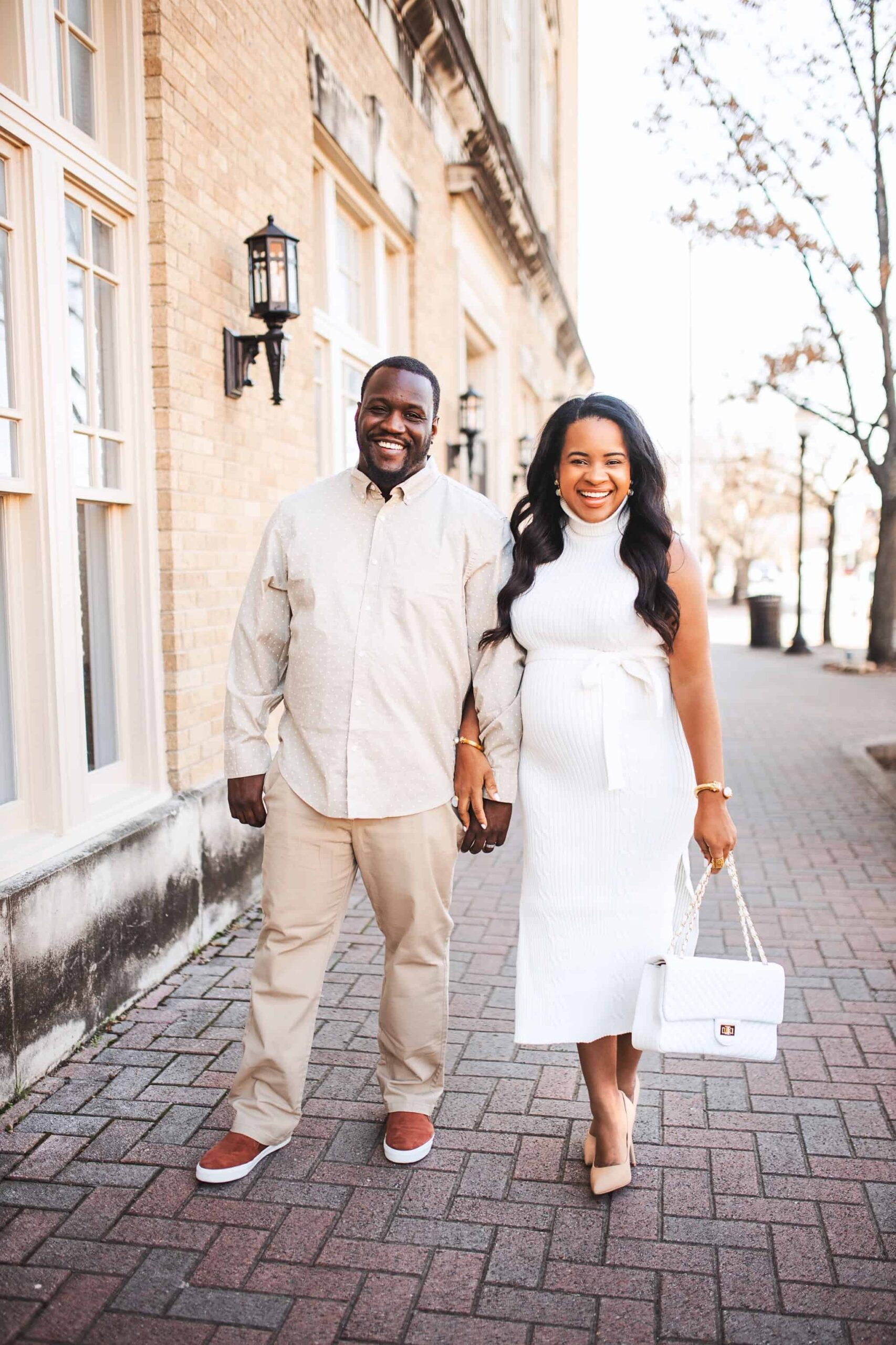 Tips for Moving to Another State by popular Nashville life and style blog, Glamorous Versatility: image of a husband and wife wearing matching white and cream outfits and holding hands. 