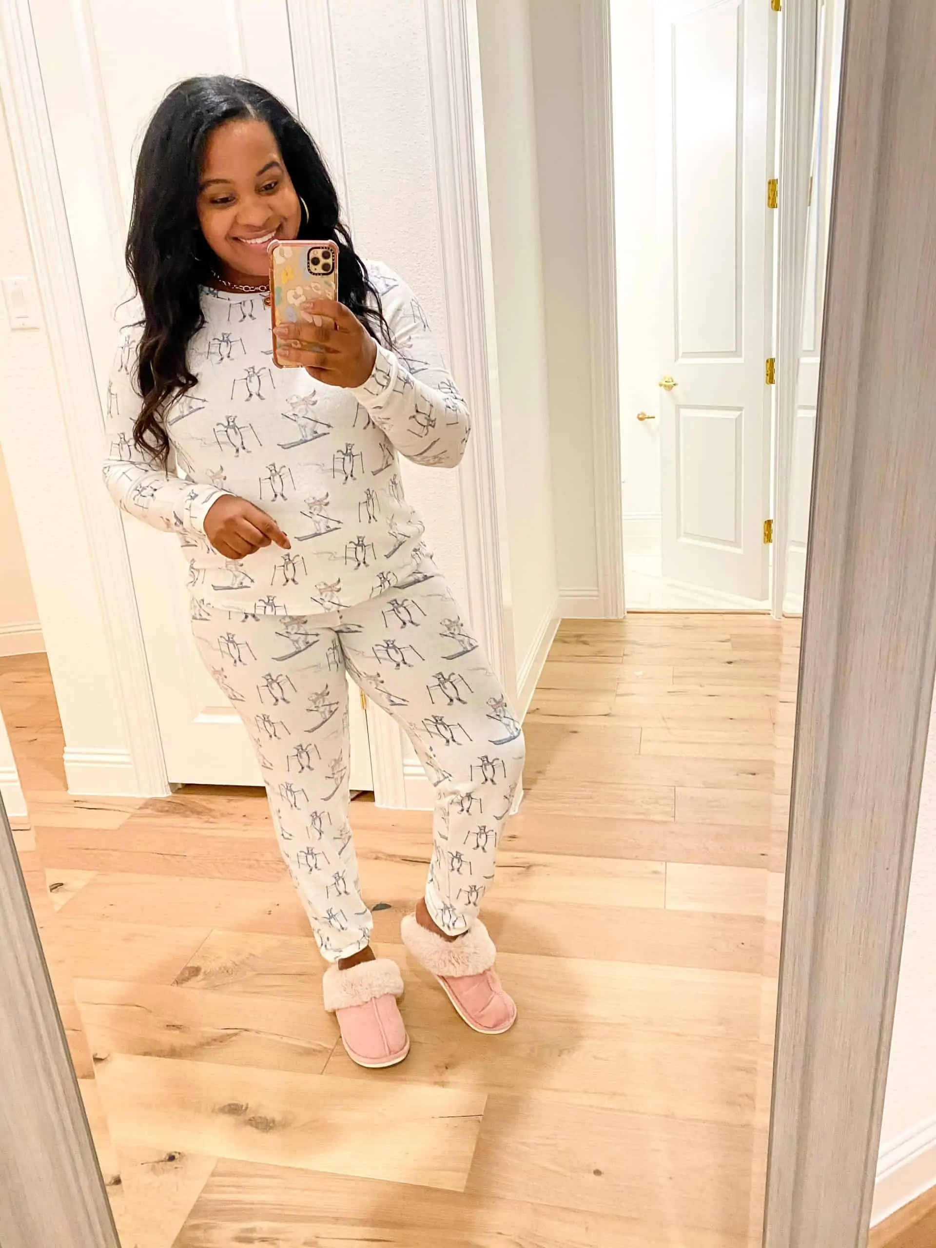 Cozy Gifts by popular Dallas life and style blog, Glamorous Versatility: image of a woman wearing a Nordstrom BP. Print Comfy Pajamas set with a pair of pink UGG slippers. 