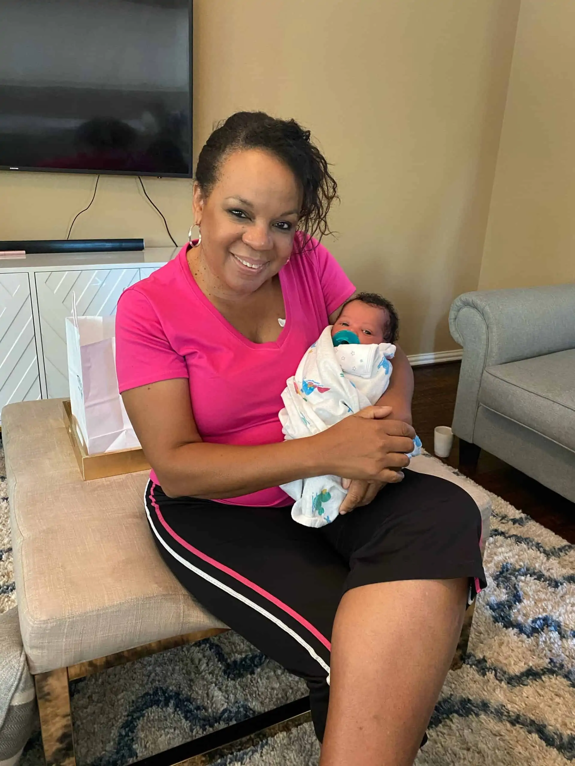 Birth Story by popular Dallas motherhood blog, Glamorous Versatility: image of a woman holding a new born baby boy. 